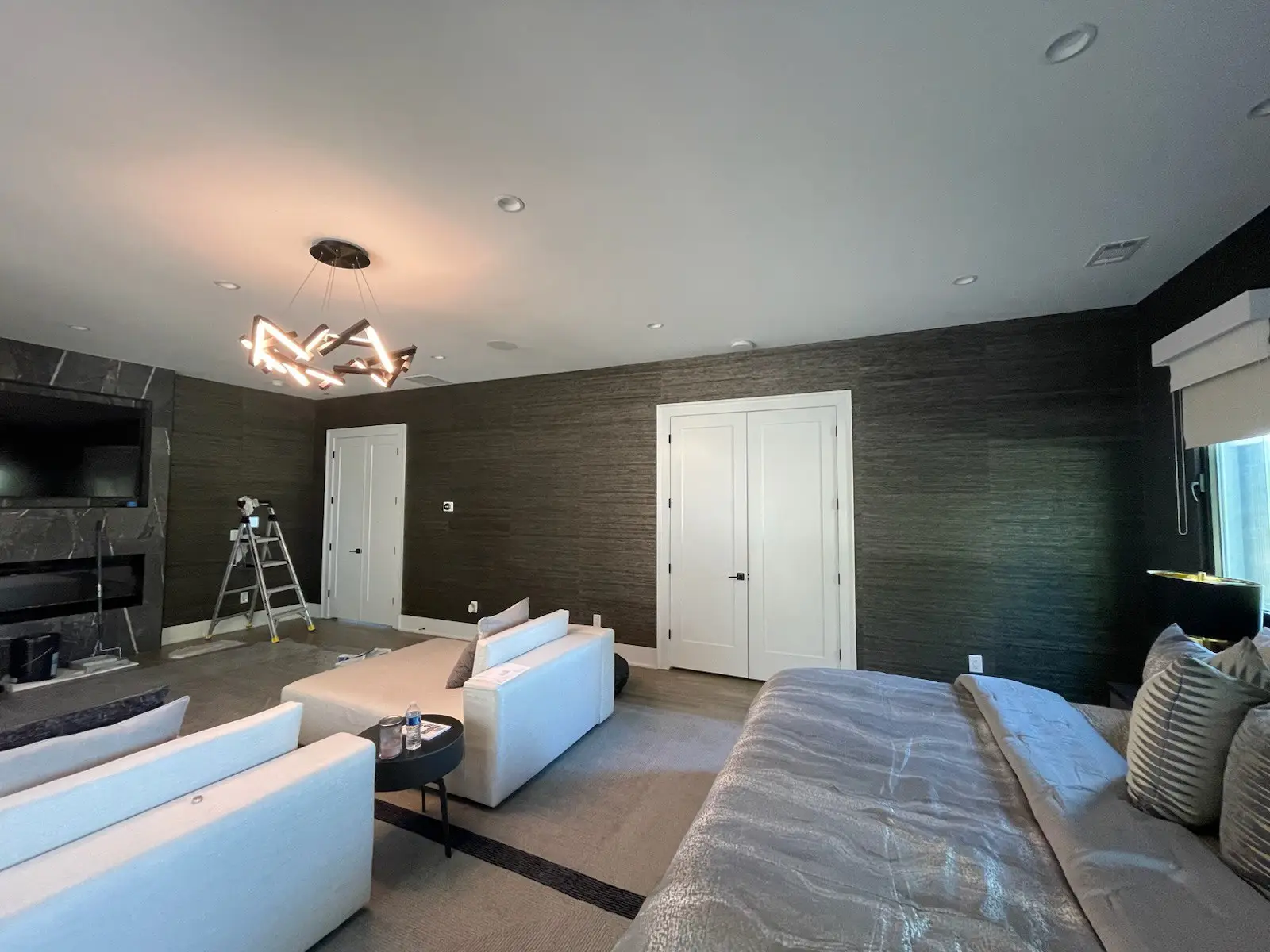 Miller Wallpaper installer carefully aligning wallpaper seams in New York